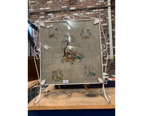 AN ORNATE VINTAGE FIRESCREEN DEPICTING VARIOUS ANIMALS 
