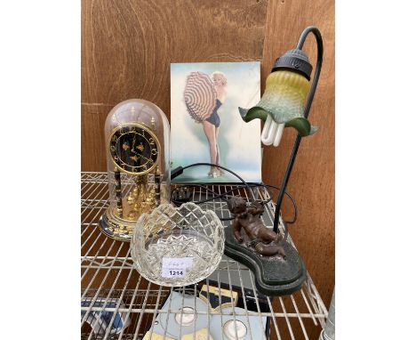 A GLASS BOWL, A DOME CLOCK, A HOLOGRAPHIC PICTURE AND A DECORATIVE TABLE LAMP WITH A CHERUB ON THE BASE 