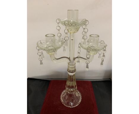 A VINTAGE GLASS THREE BRANCH CANDLESTICK WITH DROP GLASS DETAIL 