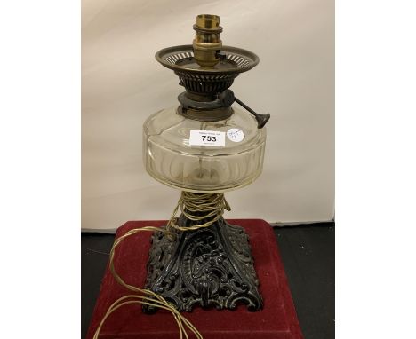A VINTAGE CAST IRON BASED CONVERTED OIL LAMP 