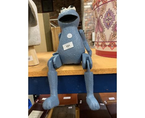 A WOODEN COOKIE MONSTER FIGURE TO SIT ON A SHELF 