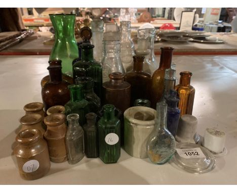 A LARGE ASSORTMENT OF CERAMIC AND GLASS MEDICINE BOTTLES 