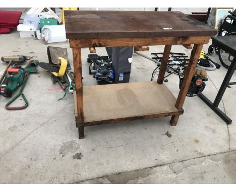 A WOODEN WORK BENCH WITH SHELF UNDERNEATH 