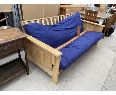 A PINE FRAMED SOFA BED 