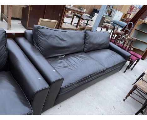 A LARGE LEATHER TWO SEATER SOFA 