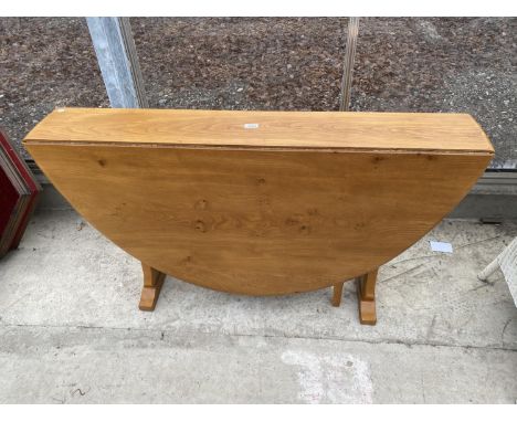 AN ERCOL OVAL ELM DROP-LEAF DINING TABLE, 56 x 50" FULLY OPEN 