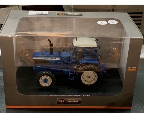 A BOXED UNIVERSAL HOBBIES DIE CAST FORD TRACTOR 1:32 