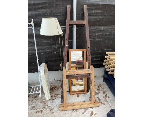 AN ARTIST'S EASEL, TWO TRESTLE STANDS, A STANDARD LAMP, A MIRROR AND TWO PRINTS 