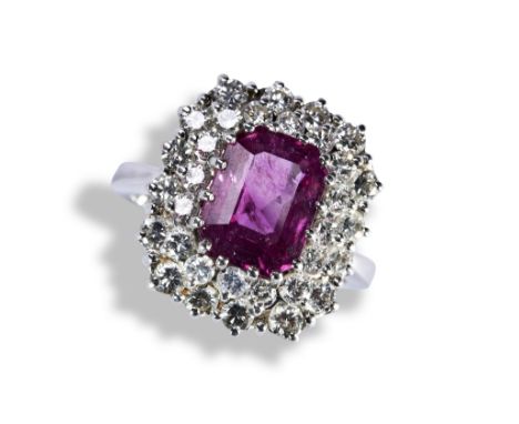 A PINK SAPPHIRE AND DIAMOND RING, the emerald-cut sapphire within a double border of brilliant-cut diamonds on a plain band.R