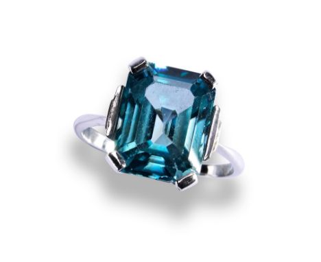 A 20TH CENTURY BLUE ZIRCON PLATINUM RING, CIRCA 1950 the emerald-cut, cut cornered zircon four claw set between stepped shoul