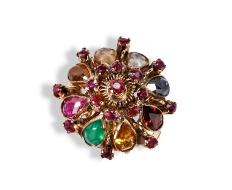 A GEM SET NAVARATNA GOLD RING of tiered design, set with a circular mixed-cut ruby above a bezel of further rubies to a slopi