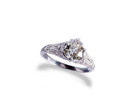 AN ART DECO DIAMOND AND PLATINUM RING  the European cut diamond, four claw set, on a pierced millegrain gallery with small pa