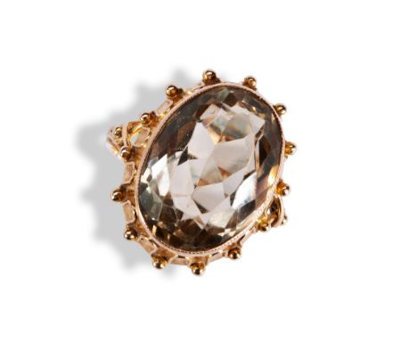 A CITRINE AND GOLD RING the central collet set oval mixed cut citrine, the gallery and split shoulder having wire and granula