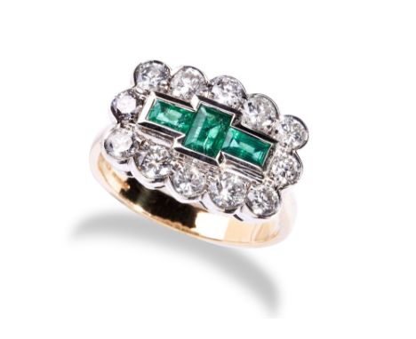 AN EMERALD AND DIAMOND RING set with three baguette-cut diamonds, collet set within a bezel of twelve brilliant-cut diamonds,