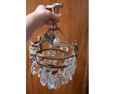 A glass chandelier (af) later adapted for electricity together with two white opaque lamp shades