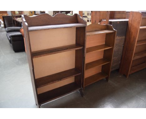 Two wooden four shelf bookshelves with carved crests 117 x 68 x 24cm and 61 x 100 x 20cm