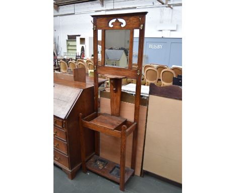 An oak hall stand with central bevelled mirror, umbrella stand and shelf 182 x 58cm