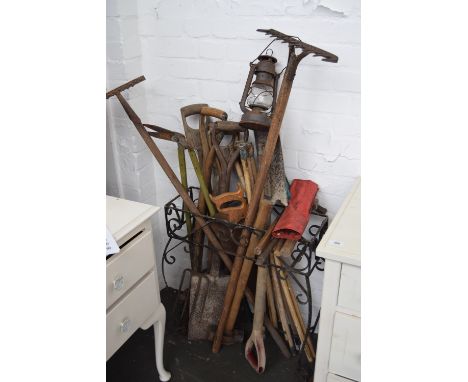 A quantity of vintage garden tools including rakes, shovel, forks, sledge hammer, shears, various hammers all in a metal umbr