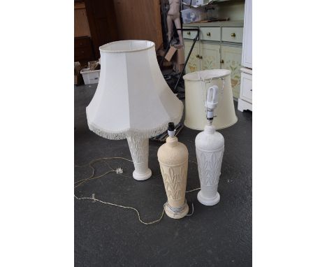 Two table lamps with moulded white base and a cream lamp base of similar design