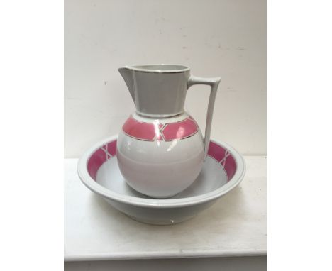 A ceramic wash bowl and jug with banded pink design heighten in gilt on cream ground together with another wash bowl by J&G M