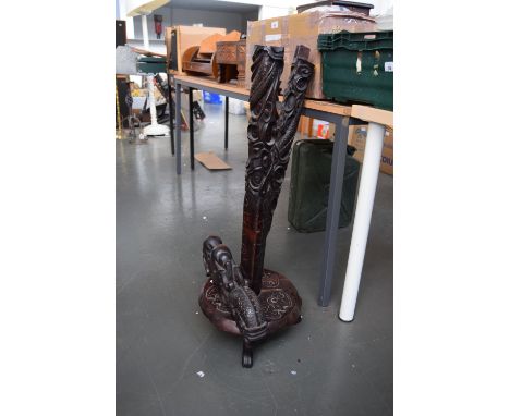 A dragon carved hardwood floor lamp, carved base raised upon three clawed feet, in three part, need rewiring