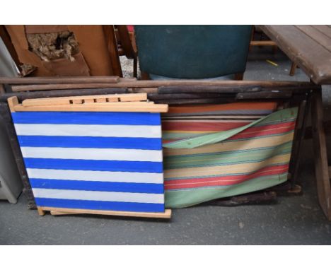 Three vintage recliners/beach chairs with striped material with one other smaller beach chair
