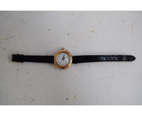 An unusual 14ct gold ladies watch with a hinged back and front cover, white enamel dial with Arabic numerals, engraved flower
