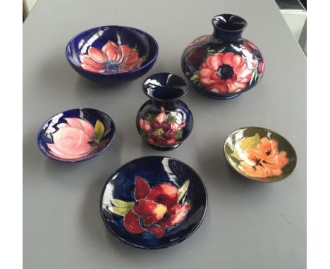 A selection of six pieces of Moorcroft pottery including two vases and four small trinket dishes, including two Anemone patte