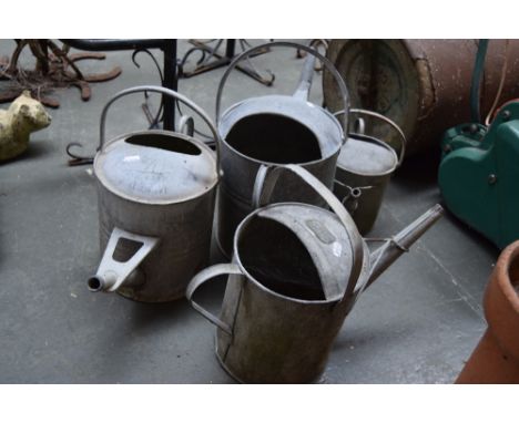Four vintage metal watering cans