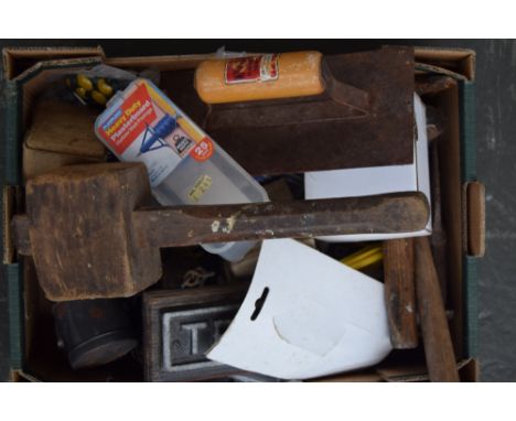 A box of tools including a wooden mallet, a plaster trowel, hammers, screws and others