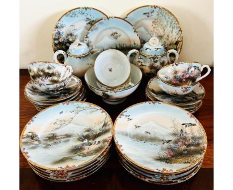 JAPANESE TEA SET INCLUDING ELEVEN SIDE PLATES, TWO SANDWICH PLATES, SLOP BOWL, ELEVEN VARIOUS SAUCERS, TEAPOT, SUGAR BASIN AN