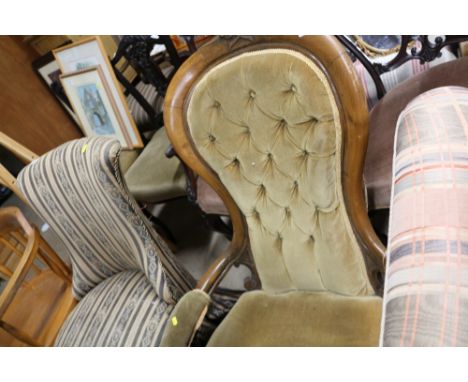 A Victorian button back armchair 