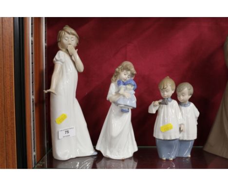 Two Nao figurines on the form of young girls; and another in the form of two choirboys 