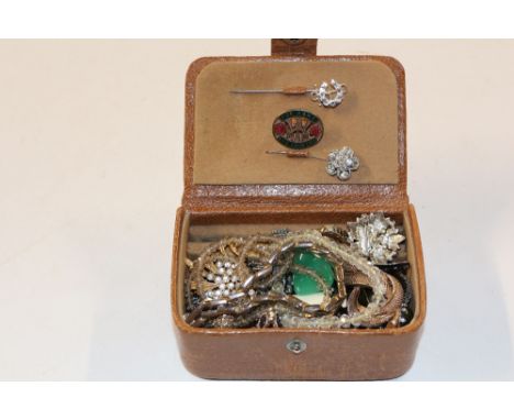 A small brown leather box of costume jewellery and stick pins 