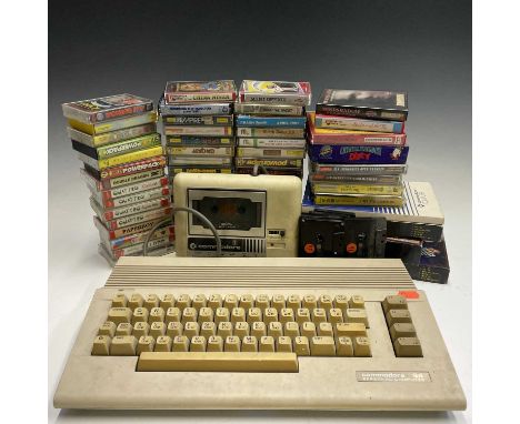 A Commodore 64 with an original cassette tape player, manual and various games.