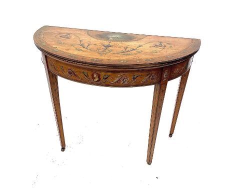 A George III painted satinwood half round fold top card table, with neo-classical style decoration on square taper legs and c