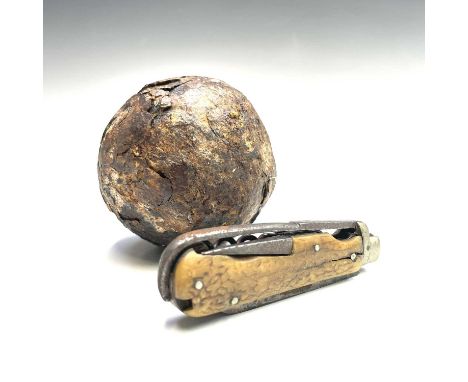 A 19th century coachman's knife, with staghorn grip, by C Johnson, length (folded) 9cm, together with an iron cannonball (2).