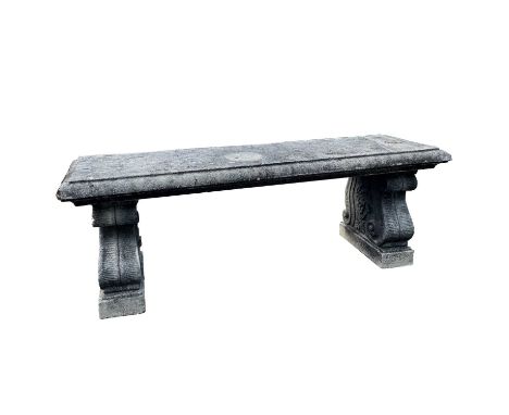 A reconstituted stone bench of neoclassical design with volute scroll ends, height 45cm width 131cm depth 40.5cmCondition rep