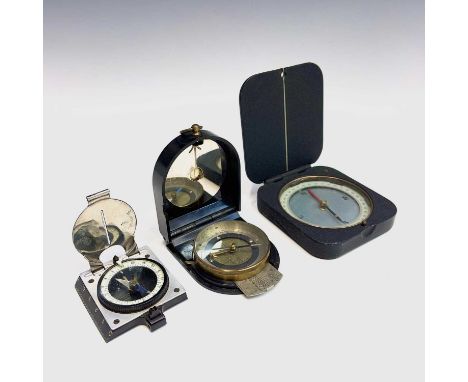 A WWII era bakelite compass with slide out metal ruler and mirror in lift up cover, together with another compass in an anodi