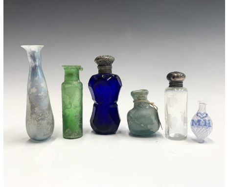 An antique miniature glass medicine bottle, circa 1660, with attached ink label indistinctly inscribed 'Medicine bottle circa