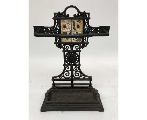 A late Victorian cast iron stick stand, in the Aesthetic taste, with central inset tile flanked by sunflower ornament, height