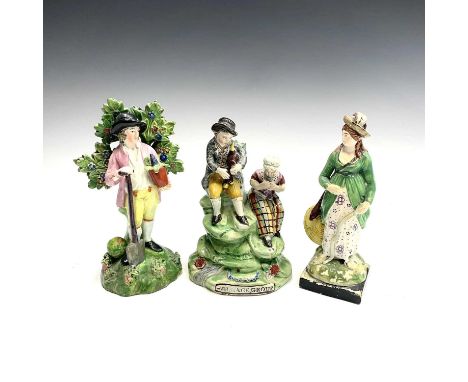 An early 19th century Staffordshire group, titled 'Village Group', with two musicians seated on a mound, height 17cm, togethe