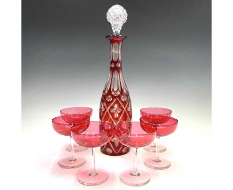 A ruby flash decanter and a stopper, height 38cm, together with a set of six cranberry glass champagne coupes (7).Provenance: