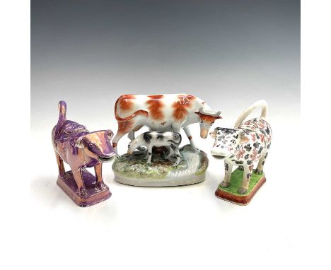 A Staffordshire cow creamer, early 19th century, with black and red sponged decoration, length 17cm, together with a 19th cen