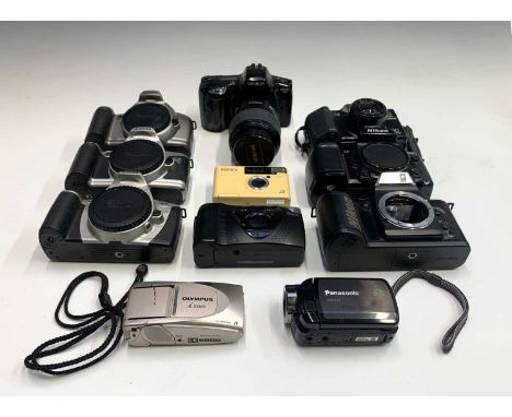 A collection of various cameras mostly film, including Panasonic SDR-S15 digital camcorder, Nikon F-401s, Minolta Dynax 3xi, 