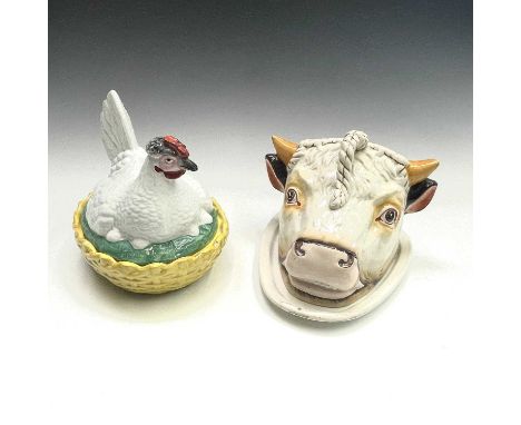 A Staffordshire cheese dish and cover, circa 1900, modelled as a bull's head, with painted detail, width 26cm, together with 