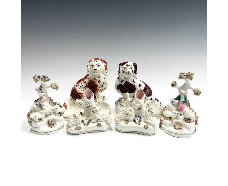 A pair of Staffordshire miniature spill vases, each with two sheep to the base, height 8cm, together with a pair of small fig