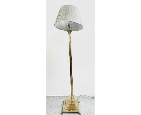 A brass Corinthian column standard lamp, the square stepped base with four paw feet, height 148cm. 