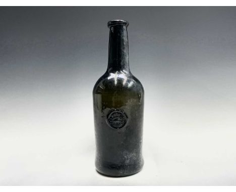 A mid 18th century sealed wine bottle, thick olive green, with kick-in base, the seal with a crown above a pig? height 28.5cm