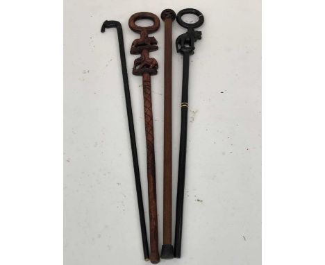 A turned oak walking stick, with seed pod knop, length 2cm, together with three African carved hardwood sticks (4).